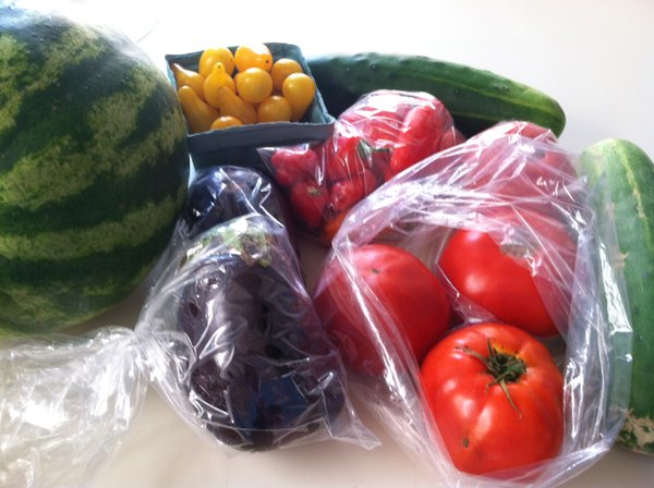 This week's goodies: Two types of tomatoes, cucumbers, eggplant, melon and little sweet peppers.