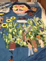 A detail of African-Americans working in cornfields from Marla Jackson&squot;s quilt, "Still We Rise," as Jackson worked to finish the project the week before the 150th anniversary of Quantrill&squot;s raid. Above are the faces of Quantrill, Bloody Bill Anderson and a free black man who rode with Quantrill, John Nolan.