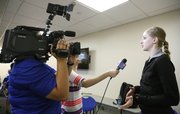 Kansas senior volleyball player Caroline Jarmoc is interviewed by members of the KU Athletics staff during a fall sports media day on Wednesday, Aug. 21, 2013, at Allen Fieldhouse.