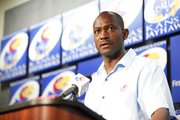 Kansas track and field coach Stanley Redwine talks with media members from the podium during a fall sports media day on Wednesday, Aug. 21, 2013, at Allen Fieldhouse.