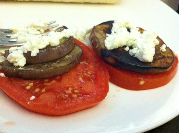 Grilled eggplant with tomato and goat cheese.