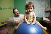 Lawrence resident Jeff Williams is pictured with his one-and-a-half-year-old son Frank on Thursday, Aug. 29, 2013. Williams and his wife Dorothy have been using cloth diapers for Frank for quite some time. Many parents are hesitant to use cloth diapers because of the perception of extra work. Jeff explained that once he and his wife worked out a system for laundering the diapers it became routine.