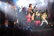 Fellow world championship air guitar contestants hoist Eric Melin on their shoulders on stage after he won the competition.