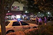 In this 2013 Journal-World file photo, Lawrence police officers talk with a college student in the 700 block of Massachusetts Street.