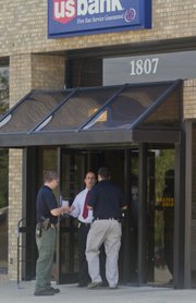 Lawrence police detectives respond to US Bank at 1807 W. 23rd St., Thursday afternoon, after a reported robbery.