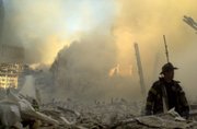 A lone firefighter moves through piles of debris at the site of the World Trade Center in New York on Sept. 11, 2001.