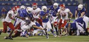 Kansas half-back Darrian Miller (6) runs through the South Dakota defense in KU's 31-14 win against South Dakota at Memorial Stadium, Saturday, Sept. 7, 2013.