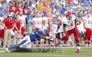 Kansas safety Dexter Linton snags South Dakota recevier Terrance Terry by the jersey before bringing him down during the second quarter on Saturday, Sept. 7, 2013 at Memorial Stadium.