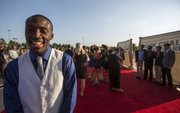 Michael Stigler stops on the red carpet to speak with reporters during the Rock Chalk Choice Awards Sunday at the Lied Center.