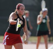 Lawrence High No. 2 singles player Kendall Pritchard returns a serve during her first-round match against Free State's Megan McReynolds, Tuesday, Sept. 10, 2013 at Lawrence High School.