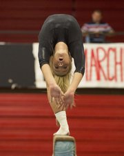 Free State's Grace Bartle bends over backwards while doing her balance beam routine during Free State's gymnastics meet Thursday at LHS.