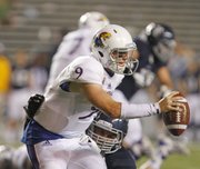 Kansas quarterback Jake Heaps is sacked on the final possession by Rice defensive tackle Christian Covington on Saturday, Sept. 14, 2013 at Rice Stadium in Houston, Texas.