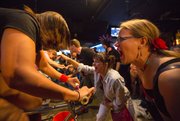 Michele Berendson, right, shouts words of encouragement to Sybil Gibbs, both of Lawrence, while Gibbs competes in a roller cycling race at Franks North Star Tavern, 508 Locus Street, on Friday, Sept. 13, 2013.