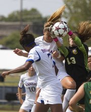 San Francisco goal keeper Madalyn Schiffel (13) pulls the ball away from Kansas' Jamie Fletcher on a Kansas corner kick during their game Sunday afternoon at the Jayhawk Soccer Complex.