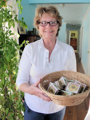 Carolyn Reid holds a basket of Carolyn's Natural Soap, which she makes at her Perry ranch with help from daughter Julie Justus.