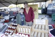 Courtney Skeeba and her son, Marek, sell the handcrafted goat butter soaps they make at their home, Homestead Ranch of Lecompton, at the Lawrence Farmers Market.