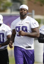 Minnesota Vikings defensive tackle Christian Ballard makes his way to the field during NFL football training camp, July 29, 2013, in Mankato, Minn. Ballard, a former Free State High standout, left Vikings camp on Aug. 18 and revealed to USA Today in a story published Wednesday that he has retired from the NFL.