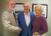 Mike Reid, left, public relations director for the Kansas Union, poses with James and Mary Ellen Ascher, who donated $130,000 to keep a 1,000-piece collection of historical Jayhawk memorabilia at the union.