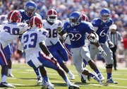 Kansas running back James Sims looks for yardage deep in Louisiana Tech territory during the second quarter on Saturday, Sept. 21, 2013 at Memorial Stadium.