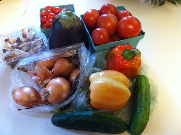 Slicing and grape tomatoes, cucumbers, mushrooms, eggplant, onions and peppers.