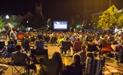 Hundreds of people flooded Massachusetts Street Thursday evening to watch the 1980s movie, The Goonies, on a large, portable movie screen set up at 11th and Massachusetts Streets.