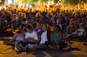 Hundreds of people flooded Massachusetts Street Thursday evening to watch the 1980s movie, The Goonies, on a large, portable movie screen set up at 11th and Massachusetts Streets.