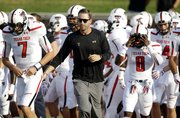 Texas Tech football coach Kliff Kingsbury runs on the field with his team before the Red Raiders’ 41-23 victory over SMU on Aug. 30 in Dallas. Kingsbury, the former Tech and New England Patriots (backup) QB, will face Kansas at 11 a.m. Saturday at Memorial Stadium.