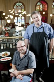 Chef/owner TK Peterson, standing, and owner Philip Wilson opened Merchants Pub & Plate, 746 Massachusetts St., in September.