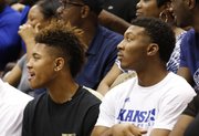 Kansas recruits Kelly Oubre, left, and King McClure watch from behind the bench during Late Night in the Phog, Friday, Oct. 4, 2013 at Allen Fieldhouse.