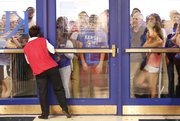 Kansas fans unable to enter pile up at an entrance on the north side of Allen Fieldhouse after the maximum amount had been let in for Late Night in the Phog, Friday, Oct. 4, 2013 at Allen Fieldhouse.