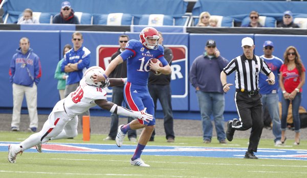 Kansas punter Trevor Pardula takes off on a fourth-down run on a fake punt against Texas Tech during the second quarter on Saturday, Oct. 5, 2013 at Memorial Stadium. Pardula was stopped on the play by Tech linebacker Micah Aw to give the Red Raiders the ball deep in Jayhawk territory.