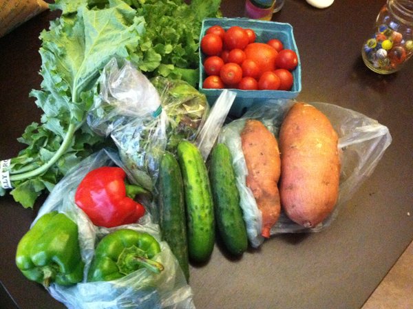 This week's haul: Roasted peppers, salad greens, cooking greens, tomatoes, cucumbers, sweet potatoes and peppers.
