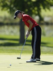 Lawrence High senior Abby Schmidtberger putts on the 18th green during the Free State Invitational on Monday, Oct. 7, 2013, at Lawrence Country Club.