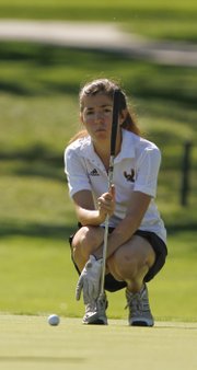 Free State junior Erin Meyers lines up a putt during the Free State Invitational on Monday, Oct. 7, 2013 at Lawrence Country Club.