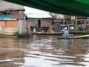 During the wet season in Belén, Peru, residents must canoe through waste-ridden waters to visit neighbors.