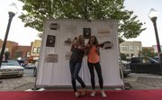 Kansas freshmen Meghan Saravanja, Junction City, and Hallie Holton, Seattle, Wash., strike a pose as a small section in the 800 block of Massachusetts Street turned into a makeshift red carpet as Downtown Lawrence Inc.'s Girls Night Downtown set up a photo booth Thursday evening. Donations from the event are going to help the Willow Domestic Violence Center.
