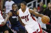Miami Heat guard Mario Chalmers (15) drives on Charlotte Bobcats guard Kemba Walker during the first quarter of a preseason NBA basketball game Friday, Oct. 11, 2013, in Kansas City, Mo.