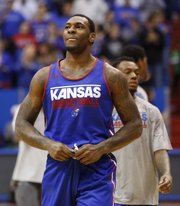 Kansas forward Tarik Black smiles as he looks up into the stands to see about ten thousand fans during an open-practice scrimmage on Saturday, Oct. 19, 2013 at Allen Fieldhouse.