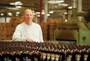 Chris Piper, a businessman and former Kansas University basketball player, now owns Grandstand Glassware and Apparel in the East Hills Business Park, the largest producer of amber glass growlers in the country.