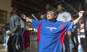 Hunter Lavallie, 11, of Lawrence shows off his dance moves as he competes, and eventually beats, Kansas basketball player Naadir Tharpe in a game of Dance Dance Revolution, Sunday afternoon at Abe & Jake's Landing. The event was part of an equipment drive put on by Bill and Cindy Self's Assists Foundation.