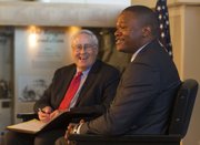 Dole Institute director Bill Lacy, left, laughs as Luvuyo Mandela, the great-grandson of former South African president Nelson Mandela, shares a story while speaking Oct. 27 at the Dole Institute of Politics. Mandela was accepting 2013 Dole Leadership Prize on behalf of his great-grandfather.