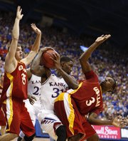 Kansas center Jamari Traylor pulls a rebound away from Pittsburg State defenders Cody Gafford (35) and Jerrod Gaston (3) during the second half of an exhibition game on Tuesday, Oct. 29, 2013 at Allen Fieldhouse.