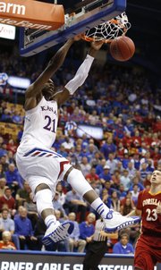 Kansas center Joel Embiid delivers a dunk against Pittsburg State during the second half of an exhibition game on Tuesday, Oct. 29, 2013 at Allen Fieldhouse.