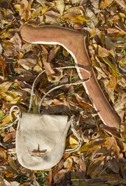 An Osage orange rabbit stick and a brain-tanned, deer skin purse by ancestral arts expert Wade Myslivy.