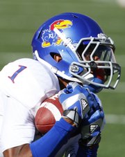 Kansas receiver Rod Coleman pulls in a catch as he falls to the ground against Texas during the second quarter on Saturday, Nov. 2, 2013 at Darrell K. Royal Stadium in Austin, Texas.