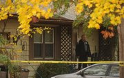 Lawrence police have arrested a man on suspicion of first degree murder in connection with the shooting death of a woman at a house in the 1600 block of West 2nd Terrace on Tuesday morning.