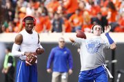 Kansas quarterbacks Montell Cozart, left, and Jake Heaps warm up prior to kickoff against Oklahoma State on Saturday, Nov. 9, 2013 at Boone Pickens Stadium in Stillwater, Oklahoma.