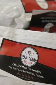 Gary and Angie Rexroad, along with their dog Rex, all from Lawrence, have developed a line of dog food called Love Grub. The food is available at Pawsh Wash, Lawrence Feed and Farm, Lucky Paws, both Hy-Vee locations and Checkers.