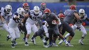 Kansas running back James Sims breaks through the West Virginia defense for yardage during the first quarter on Saturday, Nov. 16, 2013 at Memorial Stadium.