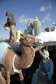 It takes about two days to set up the Nativity scene at the Hillcrest Shopping Center at Ninth and Iowa streets. Owner Dick Raney has been putting the display on the roof since about 1960.